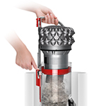 The new bin emptying mechanism, shown driving trapped dust straight into a trash can.